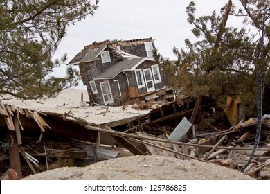 MANTOLOKING, NJ - JAN 13: A tilted house off its foundation on the beach on January 13, 2013 in Mantoloking, New Jersey. Clean up continues 75 days after Hurricane Sandy struck in October 2012.