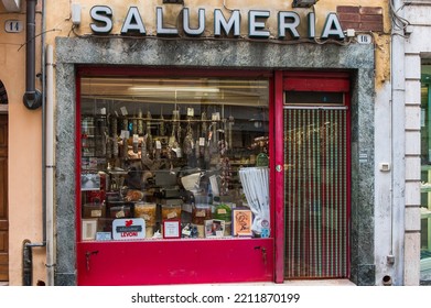 Mantua, Italy - 20-08-2022: A Typical Shop Of Italian Gastronomic Specialties With Cold Cuts And Cheese In A Window Of A Typical Street Of Mantua In Lombardy.