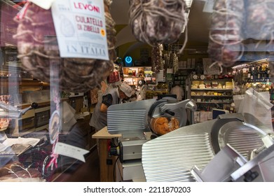 Mantua, Italy - 20-08-2022: A Typical Shop Of Italian Gastronomic Specialties With Cold Cuts And Cheese In A Window Of A Typical Street Of Mantua In Lombardy.