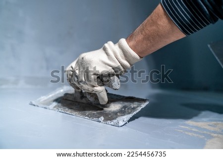 manual application of waterproofing to the wall on the construction site