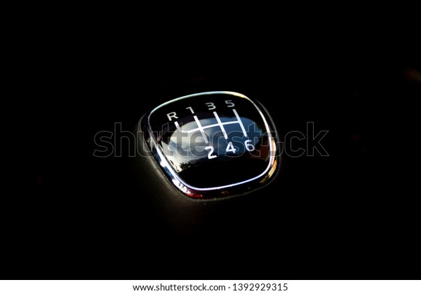 Manual car gear stick\
with sky reflection