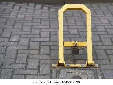 Manual car parking barrier with lock and stop sign. Car parking lock device. Dedicated parking for guests. Traffic rules, prohibitory signs