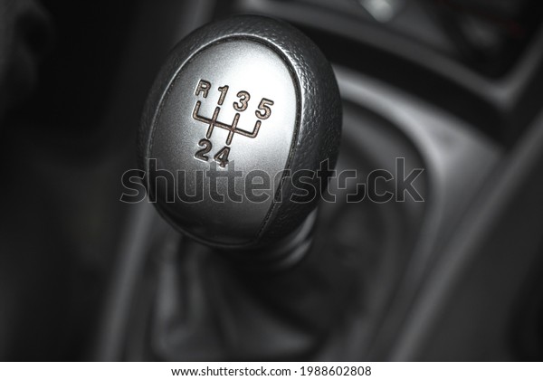 Manual car transmission close up, black\
interior automobile\
background
