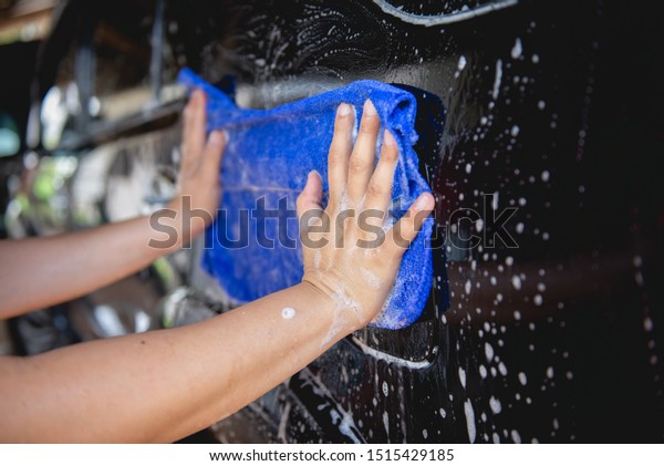 Manual car wash with\
blue car wash cloth