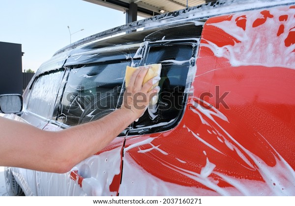 Manual car wash with\
foam sponge outdoors