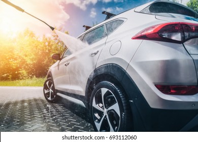 Manual car wash with pressurized water in car wash outside. - Shutterstock ID 693112060