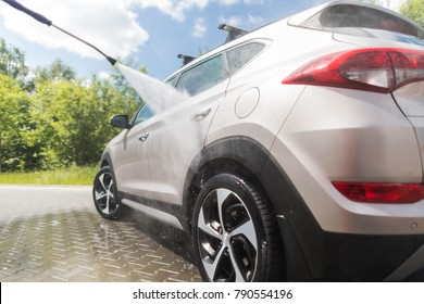 Manual car wash with pressurized water in car wash outside. - Shutterstock ID 790554196