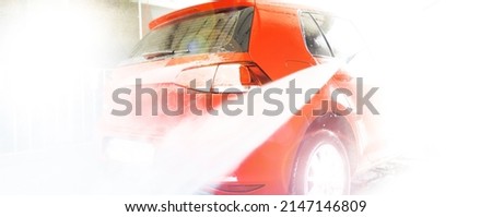 Manual car wash with pressurized water.