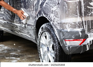 Manual Car Wash In Car Wash Shop Service With Employee Worker In Back.