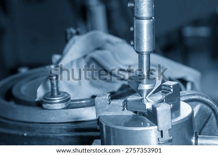 The manual chamfering and deburring process on high-precision metal workpieces. Hand tools are used to create a bevel at the edges of drilled holes, a crucial surface preparation step for safe and precise assembly.