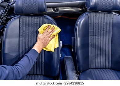 manual cleaning of the leather in the interior of the car with a micro towel - Powered by Shutterstock