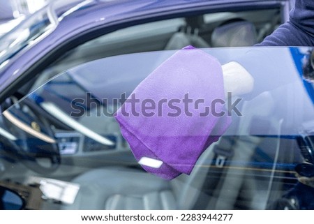 manual cleaning of luxury car windows with a microfiber towel in the garage Foto stock © 