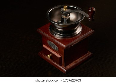Manual coffee grinder for grinding coffee beans. Black background. Vintage coffee grinder