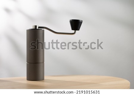Manual coffee grinder on table