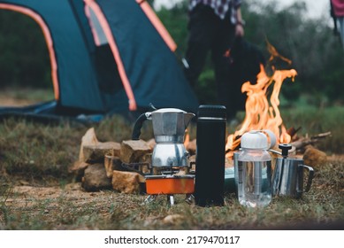 Manual equipment coffee set with bonfire in camping of people camper group in nature near the mountains, Tourism Camping Trip, Outdoor Adventure of Hiking.