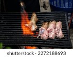 manual flamethrowers burnt raw pork knuckle. Burning food using a gas stove. Grilled Pork Knuckle, Selective focus.                  