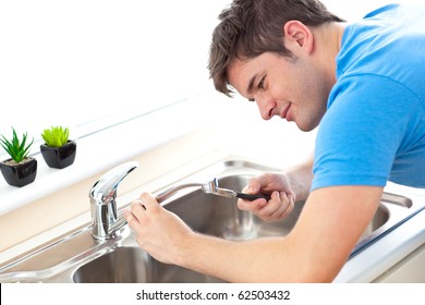 Manual Man Repairing A Kitchen Sink At Home