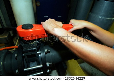 manual opening or closing a valve in an industrial plant