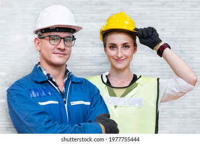 Manual People Of Woman And Man Worker Is Standing With Confident With Blue Working Suite Dress And Safety Helmet In Front Concrete Wall Background. Concept Of Smart Industry Worker Operating.