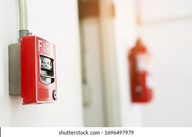 Manual Pull Fire Alarm Switch Safety System Box Installed And Fire Extinguisher On White Wall Background.