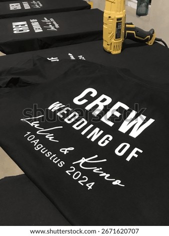 Manual screen printing process using plastisol ink on cotton fabric, perfect for themes of creative industry, fashion, printing, and handmade apparel.