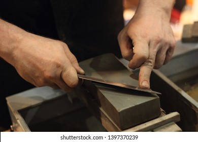 Manual Sharpening Of Knives On A Grinding Stone