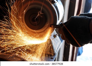 Manual sharpening of a tool on grinding machine - Powered by Shutterstock