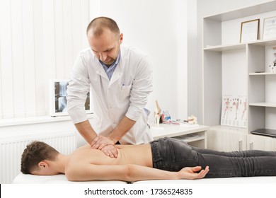 Manual Therapist Doing Manual Adjustment On Patient's Spine. Chiropractic, Osteopathy, Manual Therapy, Post Traumatic Rehabilitation, Sport Physical Therapy. Alternative Medicine, Pain Relief Concept.