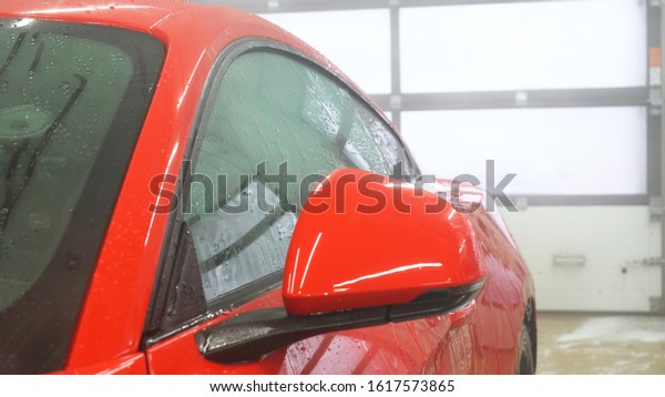 Manual wash for perfect
clean car. Cleaning car using high pressure water, Man cleaning
vehicle with high pressure water spray or jet. Car wash details,
Close up concept. 
