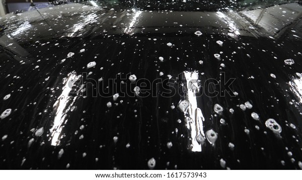 Manual wash for perfect\
clean car. Cleaning car using high pressure water, Man cleaning\
vehicle with high pressure water spray or jet. Car wash details,\
Close up concept. 
