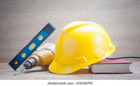 Manual work for mechanics and Yellow helmet safety for Technician equipment on learning to use worker with Still life wooden background
