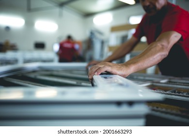 Manual Worker Assembling PVC Doors And Windows. Factory For Aluminum And PVC Windows And Doors Production.