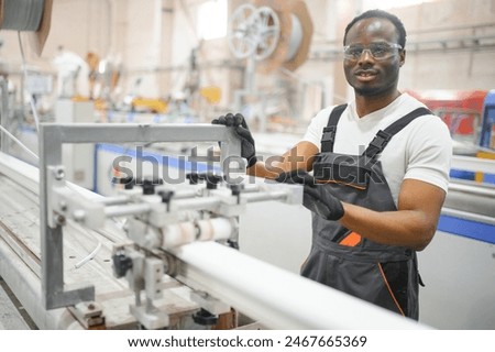 Manual worker assembling PVC doors and windows. Factory for aluminum and PVC windows and doors production.