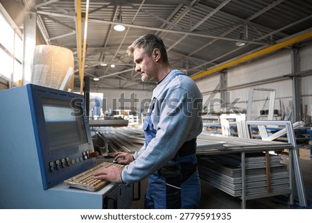 Manual worker assembling windows at factory