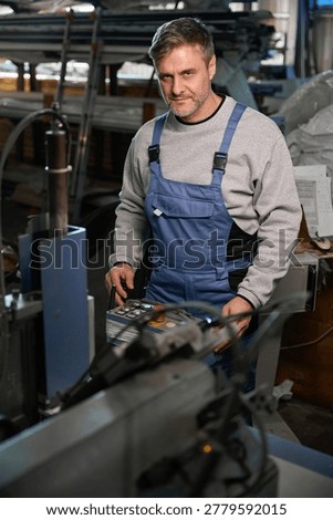 Manual worker assembling windows at factory