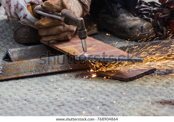 Manual  Worker cut steel with gas -  Plasma Cutting
Machine on Steel Plate