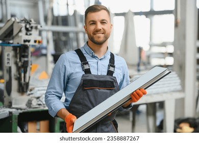 Manual worker cutting aluminum and PVC profiles. Manufacturing jobs. Selective focus. Factory for aluminum and PVC windows and doors production - Powered by Shutterstock