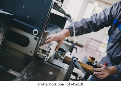 Manual Worker Cutting Aluminum And PVC Profiles. Manufacturing Jobs. Selective Focus. Factory For Aluminum And PVC Windows And Doors Production.