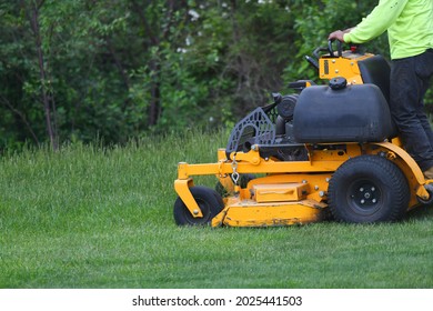 Manual Worker Mowing The Lawn