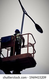 Manual Worker On A Telescopic Lifter Basket Fixing Street Light Pole.