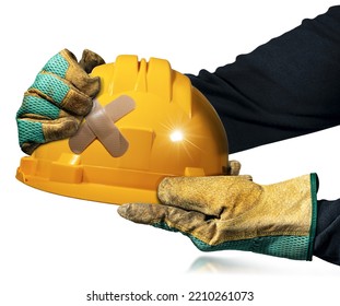 Manual Worker With Protective Work Gloves Holding An Orange Safety Helmet With A Cross Bandaid (adhesive Bandage), Isolated On White Background. Concept Of Construction Industry And Workplace Security