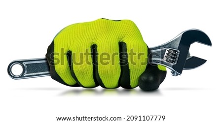 Manual worker with protective work gloves holding a stainless steel adjustable wrench, isolated on white background with reflections.