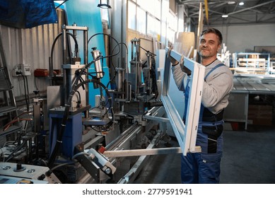 Manual worker working in factory assembling PVC windows