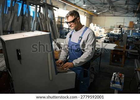 Manual worker working in factory assembling PVC windows