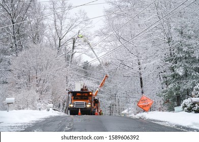 manual worker working on repair electrical line after winter snow storm     