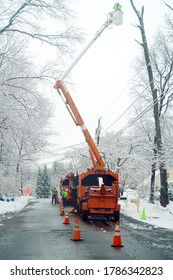 Manual Worker Working On Repair Electrical Line After Winter Snow Storm 