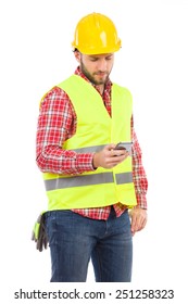 Manual Worker In Yellow Helmet And Lime Waistcoat Using A Smart Phone And Writing A Message. Three Quarter Length Studio Shot Isolated On White.