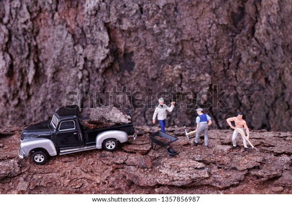 manual workers digging shoveling dirt with
pickup truck for
transport