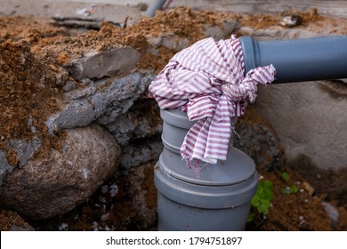manually connected plastic gray sewer pipes with a striped piece