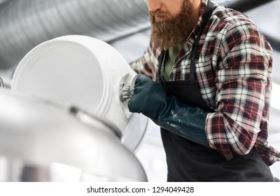 Manufacture, Business And People Concept - Close Up Of Male Brewer Working At Craft Brewery Or Beer Plant